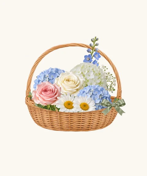 Blue and white hydrangeas, delphinium and roses in natural wicker.
