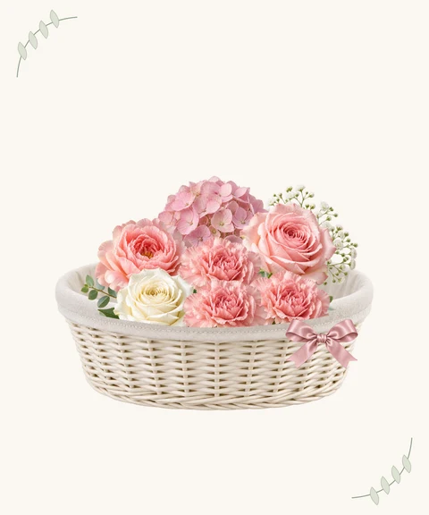 Carnations, pink hydrangeas and peonies in a soft linen-lined basket.