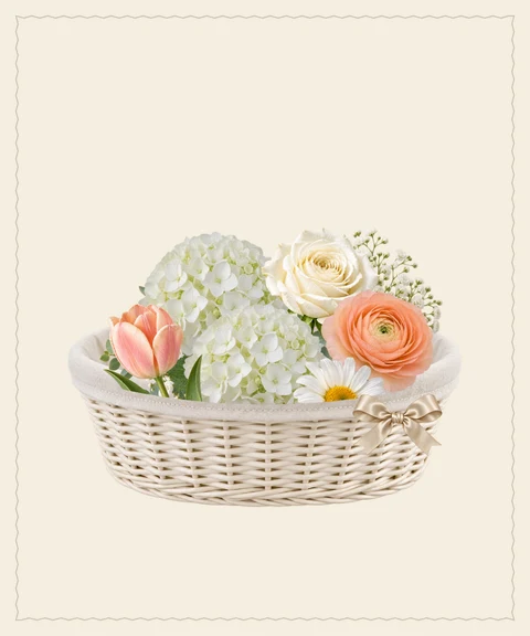 Soft white hydrangeas and peach flowers for a family’s new chapter.